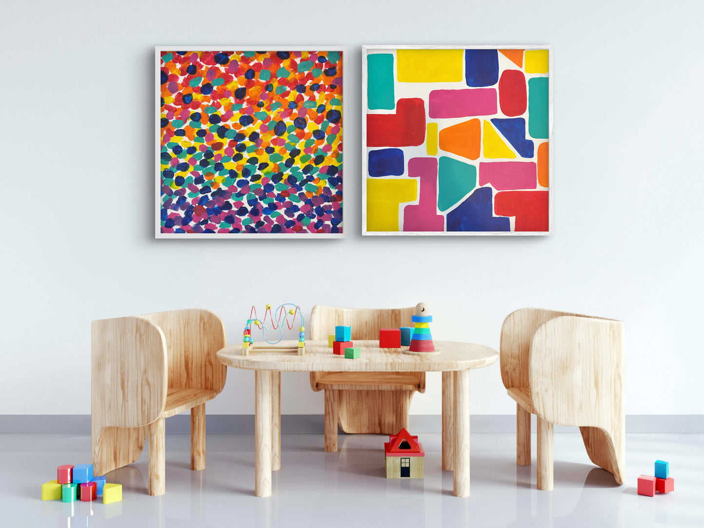 Children's play area with wooden furniture, colorful blocks, and colorful abstract art on a white wall.