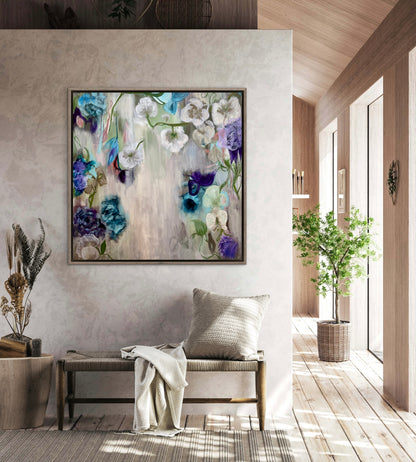 Framed floral wall art with blue, purple and white blooms on light canvas background