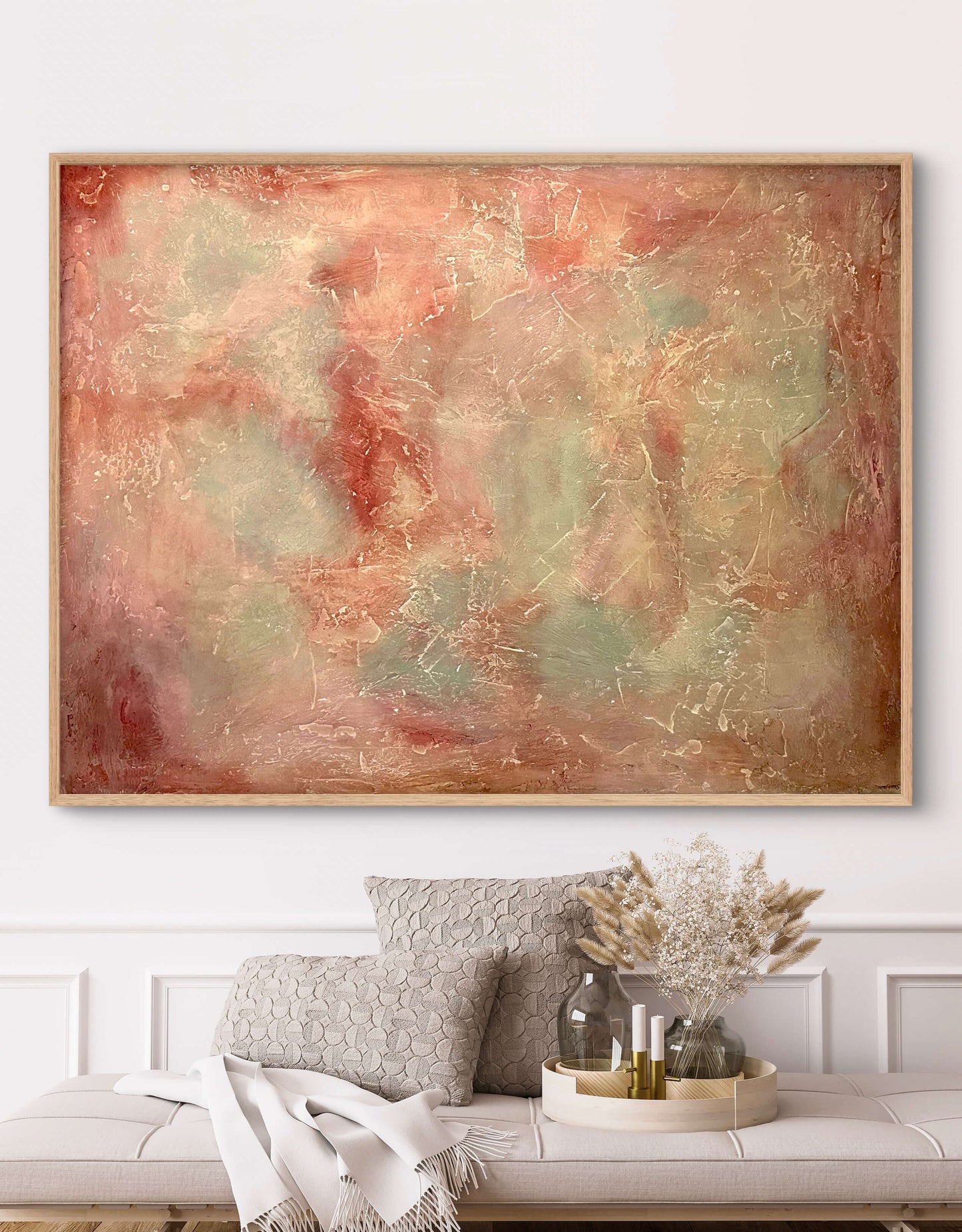 Abstract painting in a living room with a sofa and decorative items.